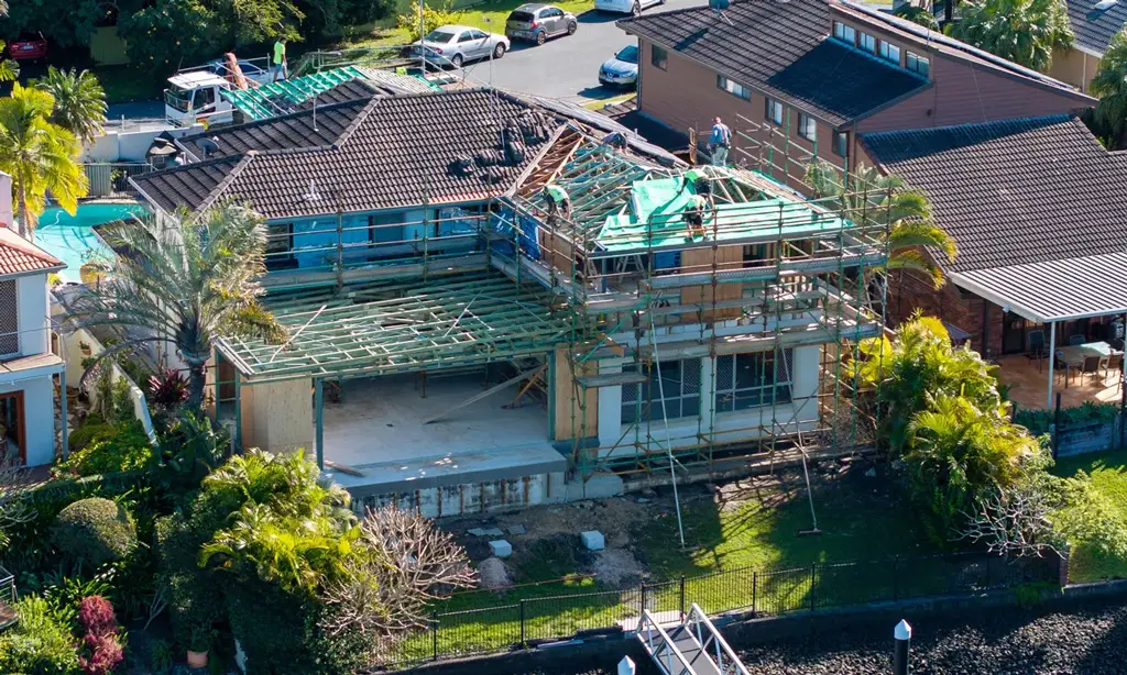 The Image Depicts A Construction Site Where Timber Wall Frames And Roof Trusses Are Being Installed, Marking A Significant Milestone In The Building Process Of A Residential Home. This Frame Stage Showcases The Essential Structural Integrity Needed For Creating A Dream Home, As Experienced Professionals Work To Ensure Quality And Safety Regulations Are Met.